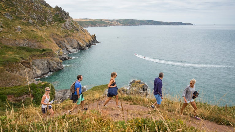 Walkers on the South West Coast Path at East Soar, Devon